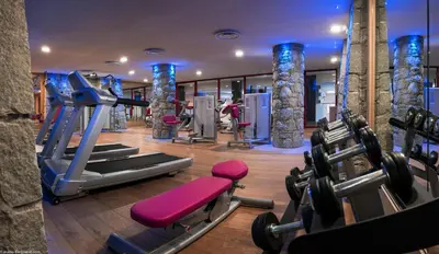 a gym with cardio equipment in a hotel room at CGH Résidence Boutique Le Centaure in Flaine