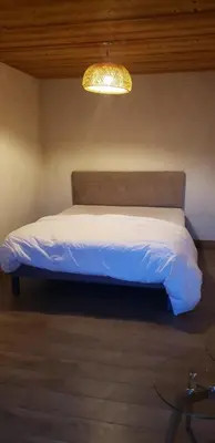 a bedroom with a colorful bed with a window at Appartement rez de jardin in Saint-Gervais-les-Bains