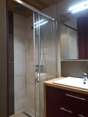 a bed in a room with a light on it at Appartement rez de jardin in Saint-Gervais-les-Bains