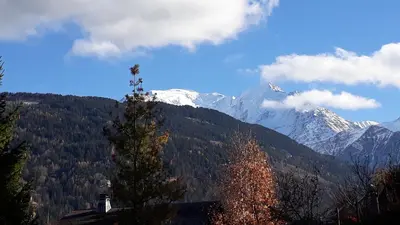 a view of a mountain with snow capped mountains at Appartement rez de jardin in Saint-Gervais-les-Bains