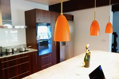a kitchen with orange pendant lights and a counter at Chalet Kizuna in Saint-Gervais-les-Bains