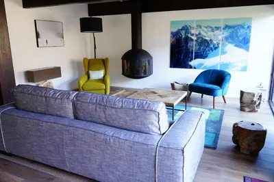 a living room with a couch and two chairs at Chalet Kizuna in Saint-Gervais-les-Bains