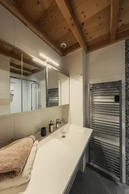 a bathroom with a white sink and a mirror at Chalet Arpitan - les Carroz - Grand Massif in Les Carroz d'Araches