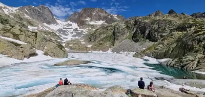a group of people standing on rocks in a mountain river at Chalet Arpitan - les Carroz - Grand Massif in Les Carroz d'Araches