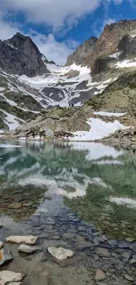 a body of water in the middle of a mountain at Chalet Arpitan - les Carroz - Grand Massif in Les Carroz d'Araches