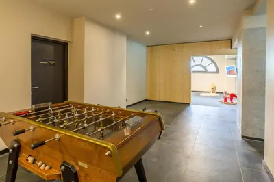 a room with a pool table in the middle at La Cordee 412 Apartment - Chamonix All Year in Chamonix-Mont-Blanc