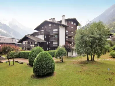 a building with a bunch of bushes and trees at Apartment Clos du Savoy-8 by Interhome in Chamonix-Mont-Blanc