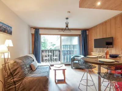 a living room with a couch and a table at Apartment Clos du Savoy-8 by Interhome in Chamonix-Mont-Blanc