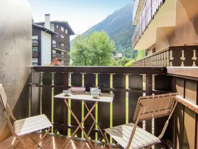 a small table and two chairs on a balcony at Apartment Clos du Savoy-8 by Interhome in Chamonix-Mont-Blanc