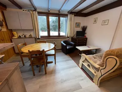 a kitchen and dining room with a wooden table at Apartment Maison Novel by Interhome in Chamonix-Mont-Blanc