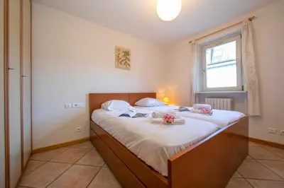 a bedroom with a large bed with flowers on it at Résidence Jardins d'Androsace 17 - Happy Rentals in Chamonix-Mont-Blanc