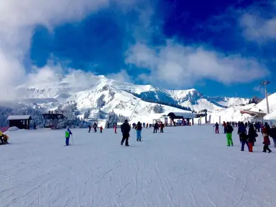 a group of people on a ski slope with a mountain at ECRINS ETOILE C9 in Samoëns