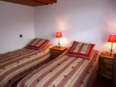 two beds sitting next to each other in a room at Grangettes in Les Carroz d'Araches