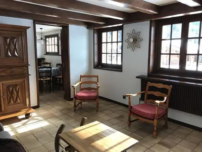 a room with two chairs and a table and windows at Grangettes in Les Carroz d'Araches