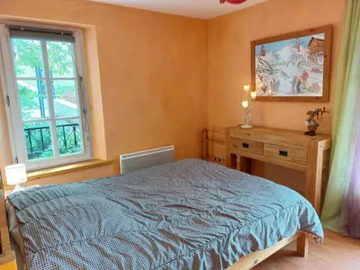 a house with blue shutters and a wooden table at Apartment Conseil 1 by Interhome in Saint-Gervais-les-Bains