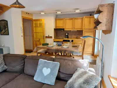 a kitchen with a wooden table and chairs and a dining room at Apartment Conseil 1 by Interhome in Saint-Gervais-les-Bains
