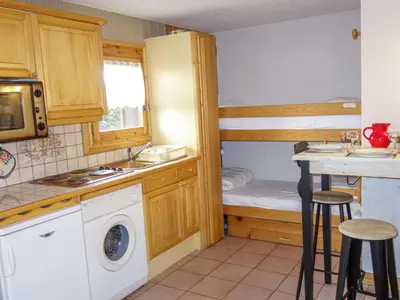 a living room with a couch and a kitchen at Apartment Jardins Alpins 1 by Interhome in Saint-Gervais-les-Bains