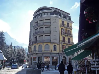 a large building in front of a mountain at Apartment Le Carlton-5 by Interhome in Chamonix-Mont-Blanc