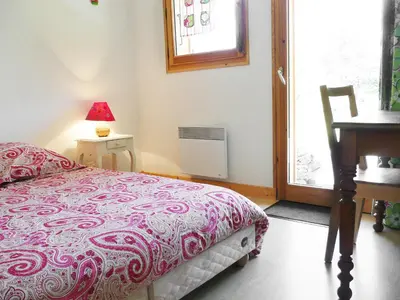 a bedroom with a bed and a table and a window at Chalet du Bulle by Interhome in Saint-Gervais-les-Bains