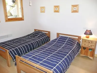 two beds sitting next to each other in a bedroom at Chalet du Bulle by Interhome in Saint-Gervais-les-Bains