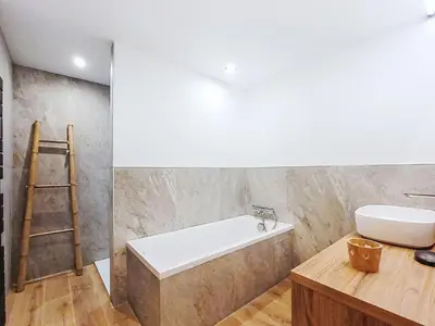 a bathroom with a sink and a bath tub at Chalet du Bulle by Interhome in Saint-Gervais-les-Bains