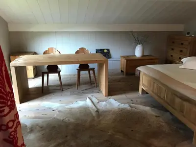 a room with a wooden table and two chairs at Thendia Montblanc in Les Houches