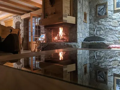 a fireplace in a room with a stone wall at Thendia Montblanc in Les Houches