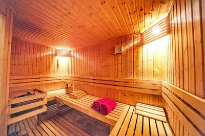 a wooden sauna with a pink towel on a bench at Thendia Montblanc in Les Houches