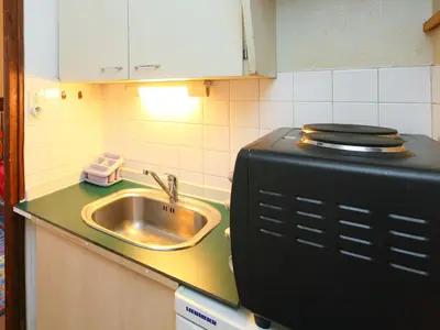 a kitchen counter with a sink and a microwave at Apartment Les Periades by Interhome in Chamonix-Mont-Blanc