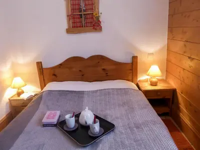 a bedroom with a bed with a tray with two tea pots at Apartment Le Krystor by Interhome in Chamonix-Mont-Blanc