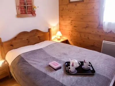 a bedroom with a bed with a tray with two dishes at Apartment Le Krystor by Interhome in Chamonix-Mont-Blanc
