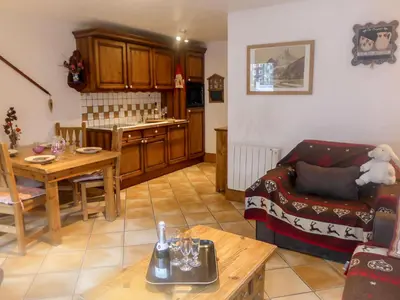 a living room with a couch and a table at Apartment Le Krystor by Interhome in Chamonix-Mont-Blanc