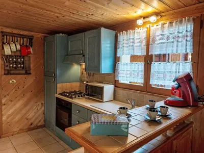 a room with a bed in a wooden wall at Apartment Rubigny by Interhome in Saint-Gervais-les-Bains