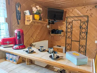 a wooden room with a table with cups on it at Apartment Rubigny by Interhome in Saint-Gervais-les-Bains