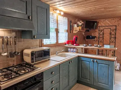 a kitchen with a table with plates and utensils on it at Apartment Rubigny by Interhome in Saint-Gervais-les-Bains