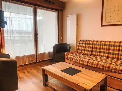 a living room with a couch and a coffee table at Apartment L'Espace Montagne-11 by Interhome in Chamonix-Mont-Blanc