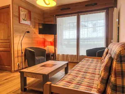 a living room with a bed and a table at Apartment L'Espace Montagne-11 by Interhome in Chamonix-Mont-Blanc