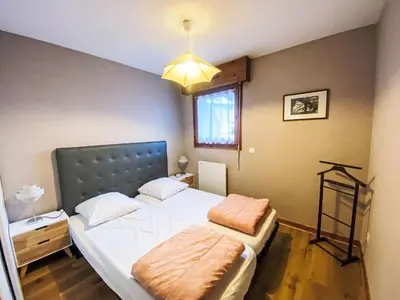 a bedroom with a large bed and a window at Apartment L'Espace Montagne-11 by Interhome in Chamonix-Mont-Blanc