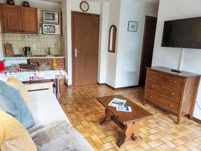 a kitchen with a table with a table cloth on it at Apartment Les G'rets-4 by Interhome in Saint-Gervais-les-Bains