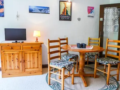 a red couch sitting in a living room at Apartment Les Pècles by Interhome in Chamonix-Mont-Blanc