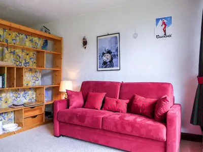 a room with a table and chairs and a television at Apartment Les Pècles by Interhome in Chamonix-Mont-Blanc