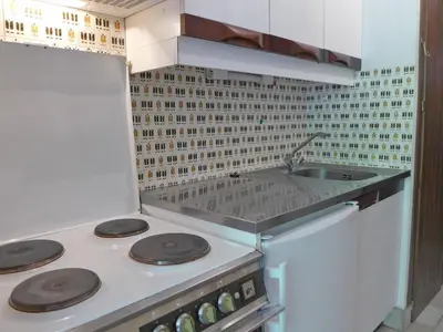a kitchen with a stove and a sink at Apartment Les Pècles by Interhome in Chamonix-Mont-Blanc