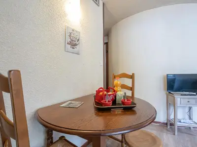 a dining room table with chairs and a plate of food on it at Apartment Le Mummery-4 by Interhome in Chamonix-Mont-Blanc