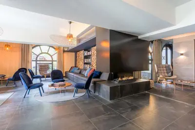 a living room with a couch and a fireplace at La Cordée - Charmant Appartement – 4 personnes in Chamonix-Mont-Blanc