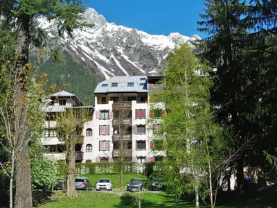 a building in front of a snow covered mountain at Apartment Jonquilles-7 by Interhome in Chamonix-Mont-Blanc