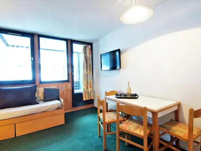 a room with a table and a bed and a table and chairs at Apartment Le Grépon-1 by Interhome in Chamonix-Mont-Blanc