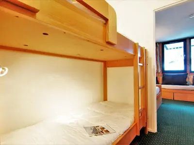 a bedroom with a bunk bed with a magazine on it at Apartment Le Grépon-1 by Interhome in Chamonix-Mont-Blanc