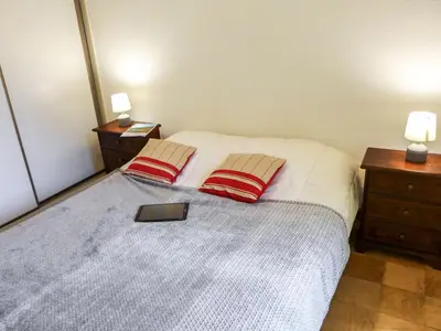 a bedroom with a bed with two red pillows at Apartment L'Univers by Interhome in Chamonix-Mont-Blanc