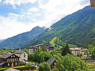 a town in front of a mountain with houses and trees at Apartment L'Univers by Interhome in Chamonix-Mont-Blanc
