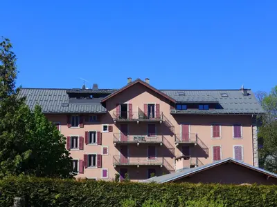 a large pink building with balconies and a roof at Apartment L'Univers by Interhome in Chamonix-Mont-Blanc